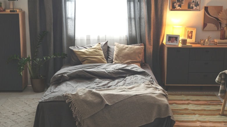 A bedroom with several rugs partially layered over each other