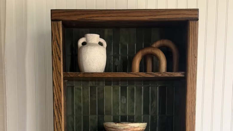 Connor Sweeney's finished thrift store cabinet in a walnut stain with green tile peel-and-stick backsplash