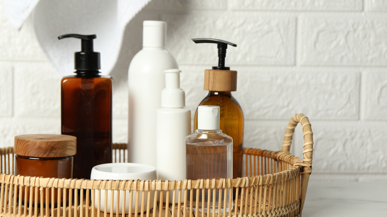 Rattan tray with bottles of cosmetic products on top