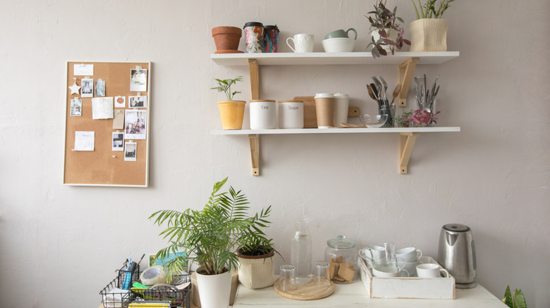 Work area with framed memo board and open storage shelves