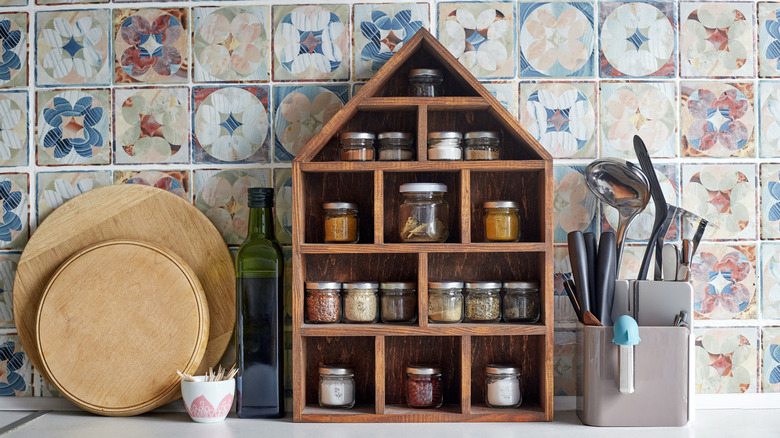 House-shaped wood spice rack shelf on kitchen counter
