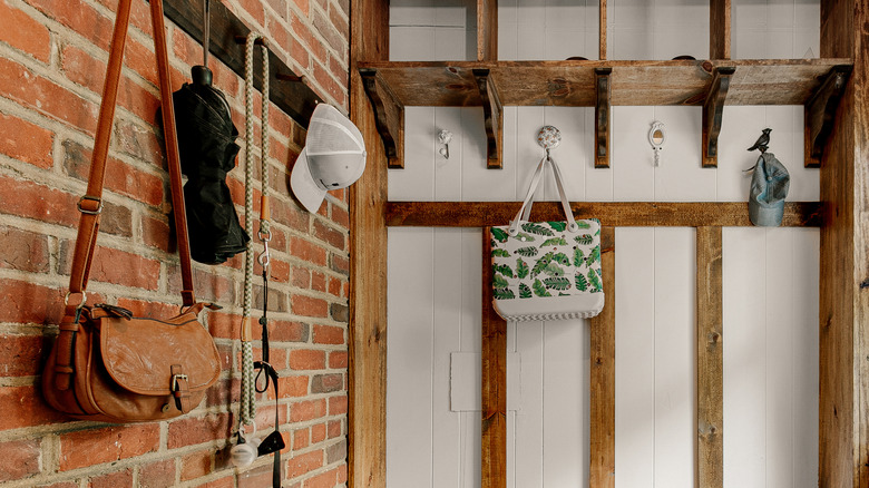 Vintage-style hooks and racks in mudroom