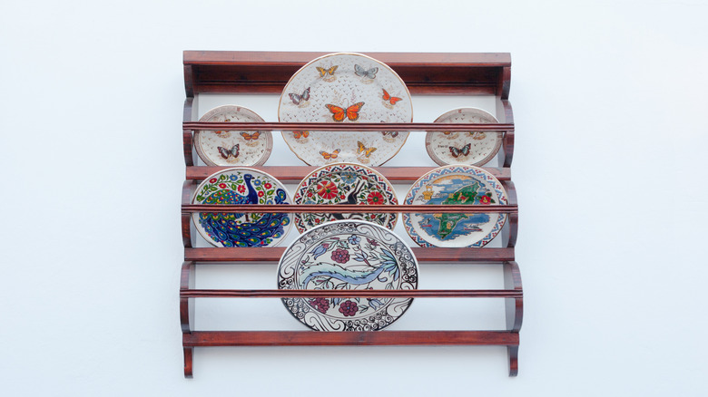 Antique wall-mounted plate rack with decorative plates
