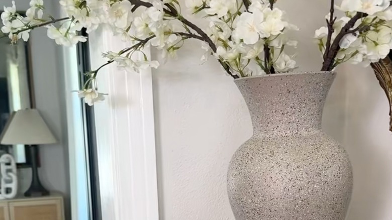 Thrifted glass vase with white floral stems