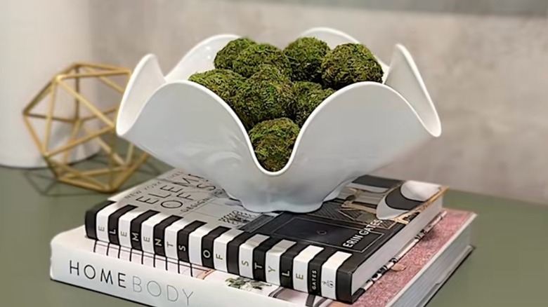 Glass bowl sitting on a stack of books