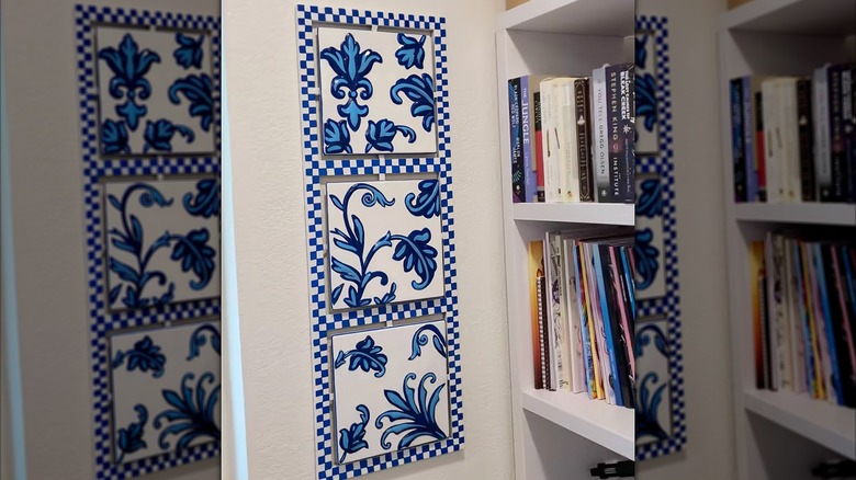 Closeup of painted metal decor hanging on a wall