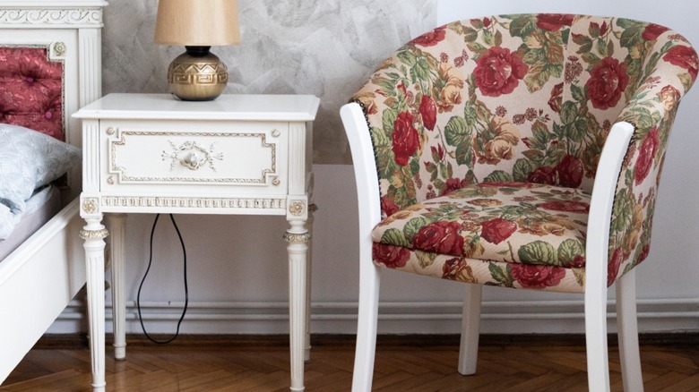 Floral pattern chair next to an end table