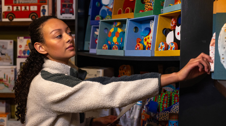 A person shopping through a toy aisle
