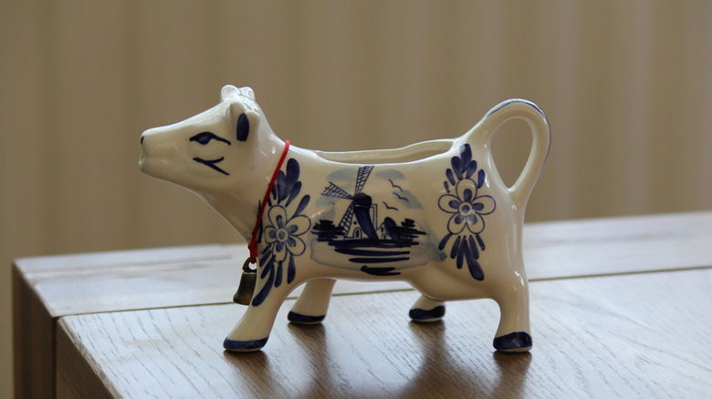 A blue and white cow creamer on table