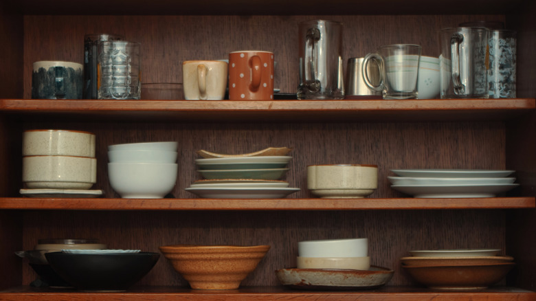 variety of different glassware arranged in storage cabinet
