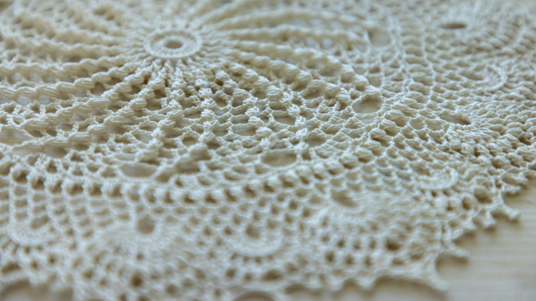 close-up of a vintage cream doily on a surface