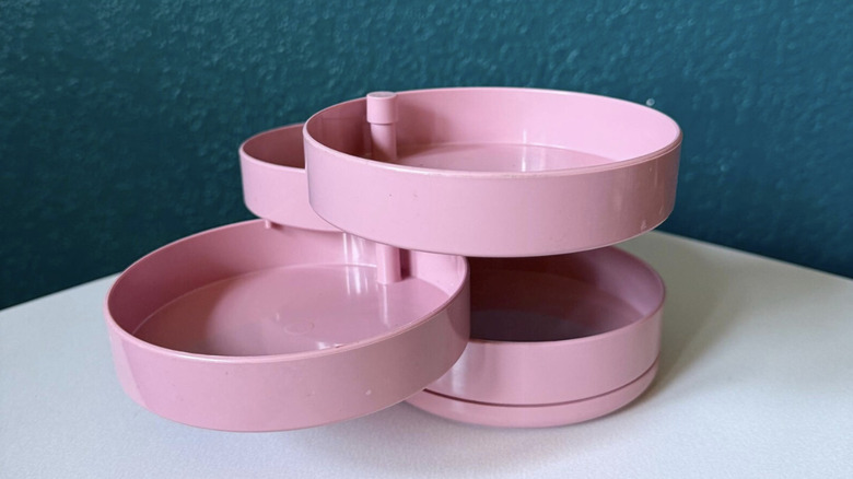Vintage pink Interdesign swivel organizer on a white table