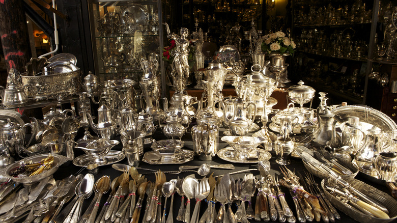Antique silverware displayed in store.