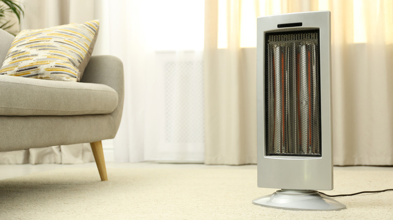 space heater on floor with couch