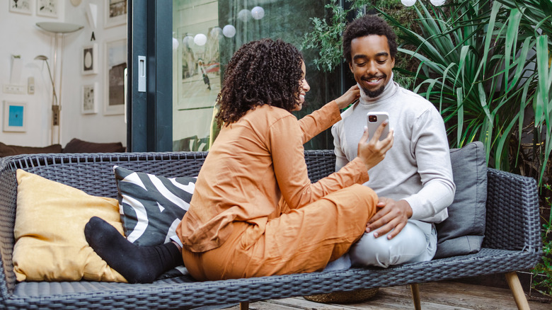 Couple looking at phone outdoors