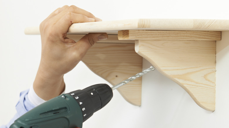 Person installing shelf 