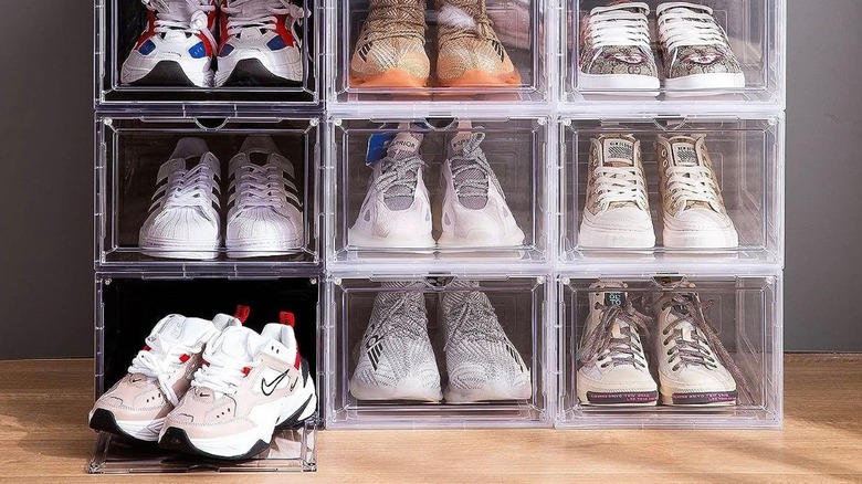 shoes stored in plastic bins in bedroom