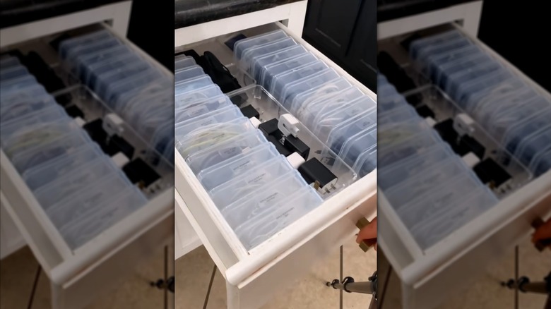 Person organizing loose cords in bead cases