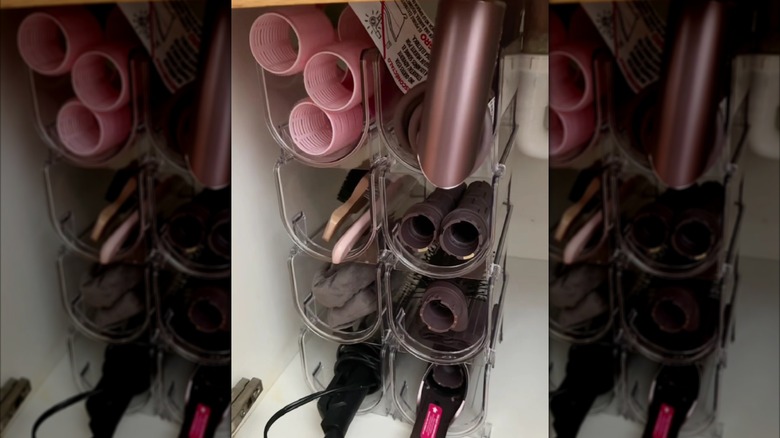 wine holder with hair tools in bathroom vanity