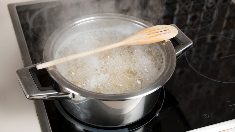 Wooden spoon by boiling water