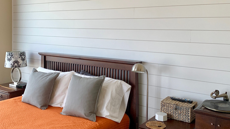 shiplap wall behind bed