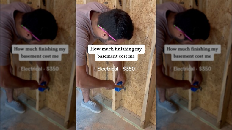 man wiring an unfinished basement
