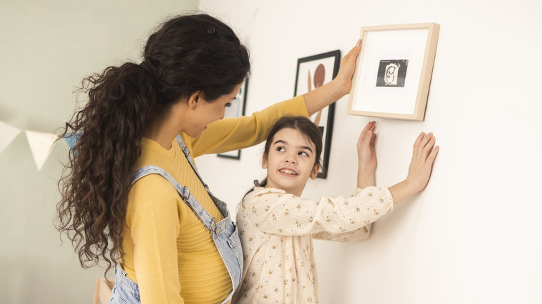 mum and daughter hanging photo