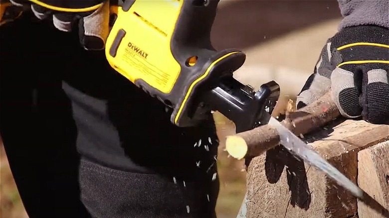 person using DeWalt reciprocating saw