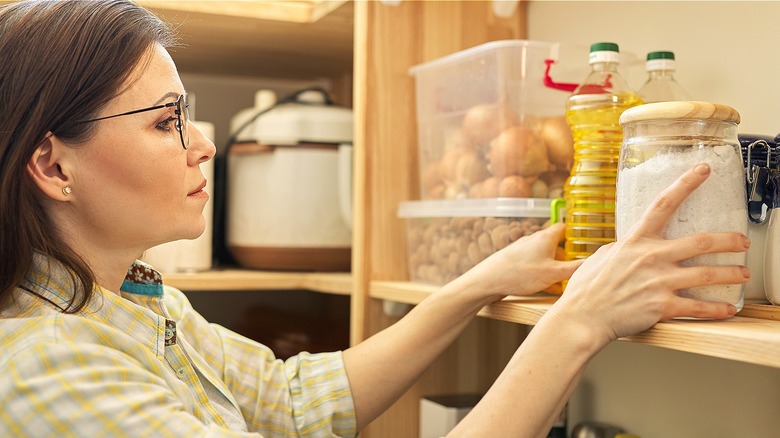 Person organizing kitchen pantry