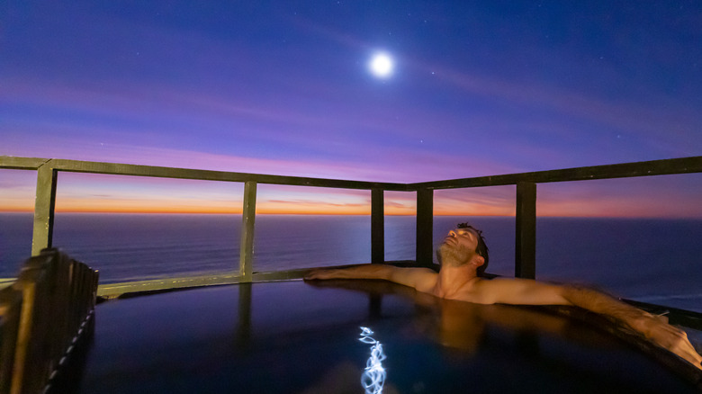 Man relaxing in hot tub at night