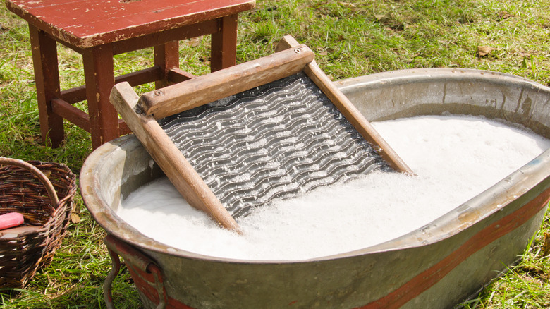 Vintage washboard in bathtub outside