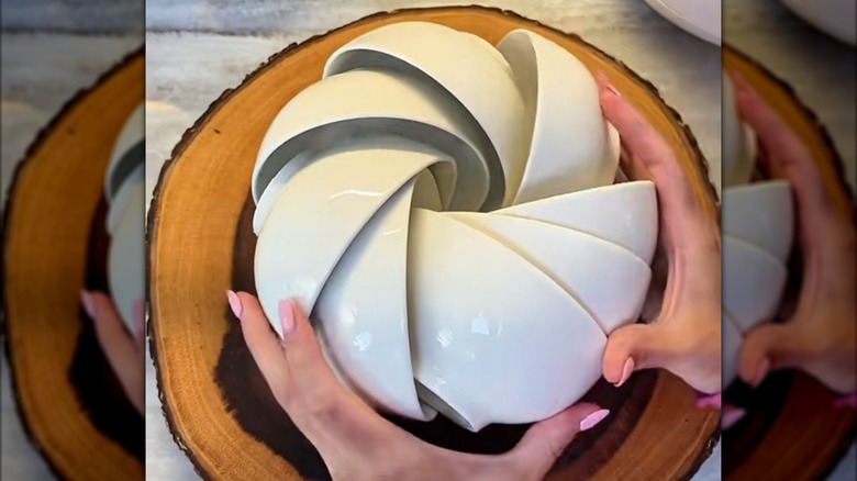 Person arranging bowls in a circle
