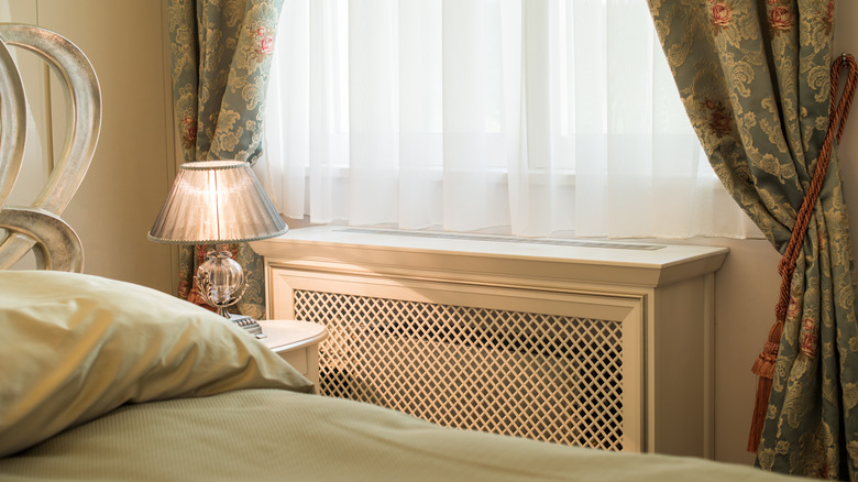 Bedroom corner with covered radiator