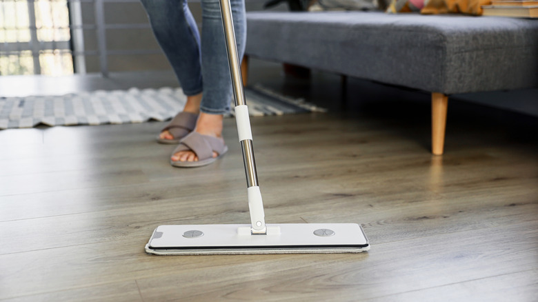 woman mopping vinyl plank floor