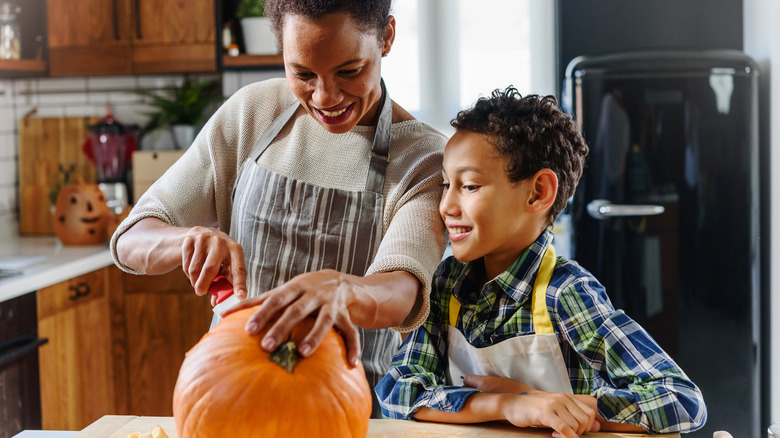 Family with carved Halloween pumpkin