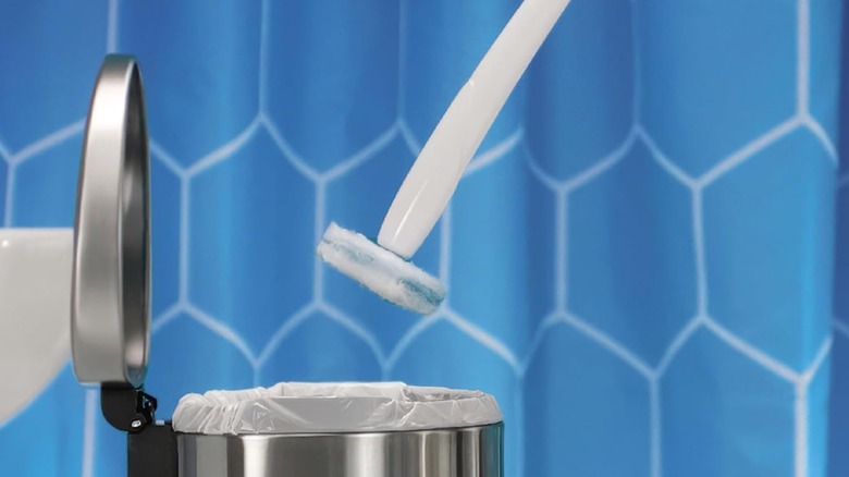 A Clorox Toilet Wand hovers over a stainless steel garbage can