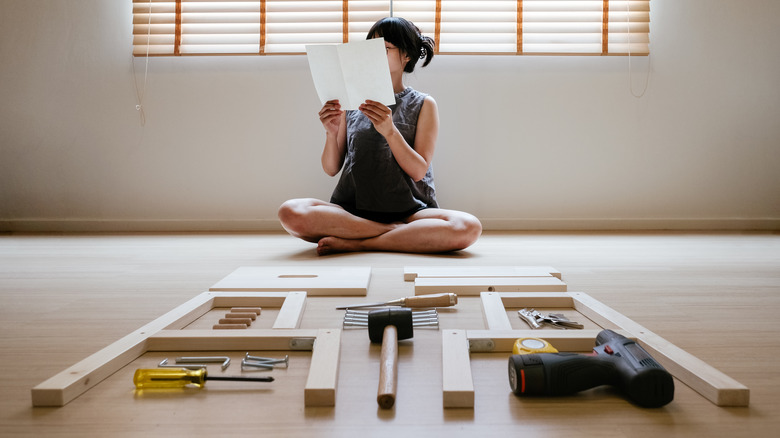 Woman ready to put together furniture