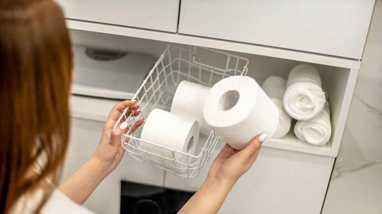 woman organizing tissue in pantry