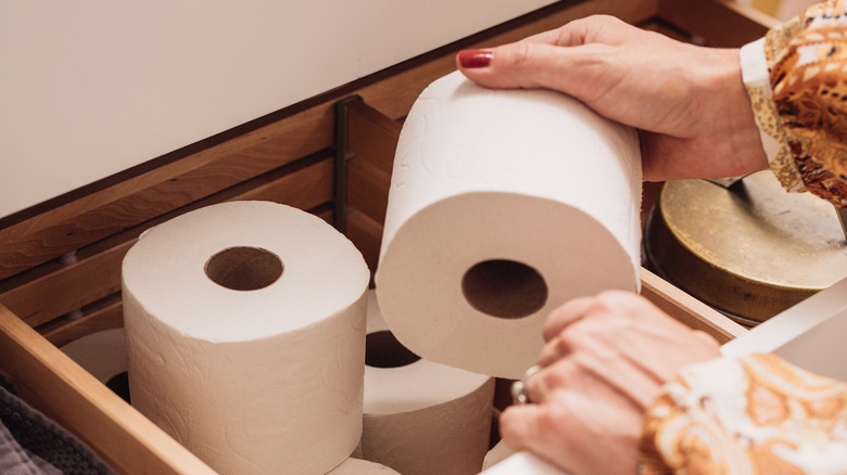 woman grabbing toilet roll 