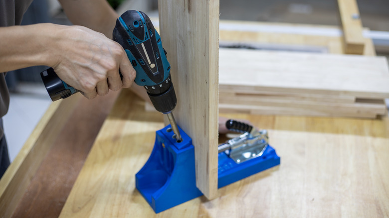 person drilling pocket holes with a jig