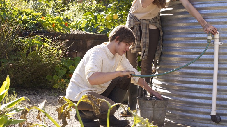 man filling bucket with water