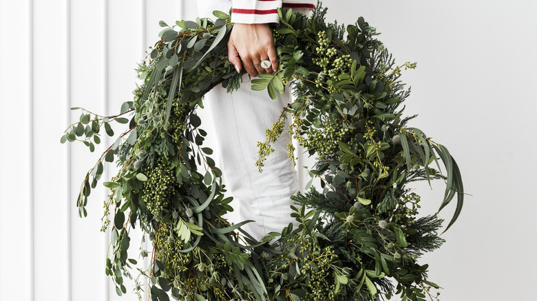person holding wreath