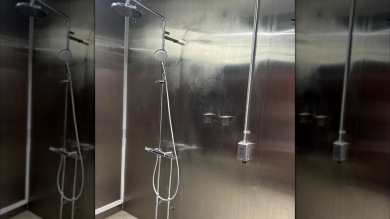 A shower with stainless steel covering the walls
