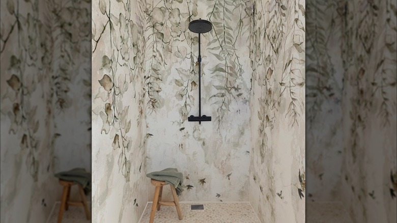 A shower that contains walls decorated and covered with wallpaper