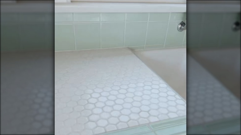 White penny tiles on a countertop next to a sink