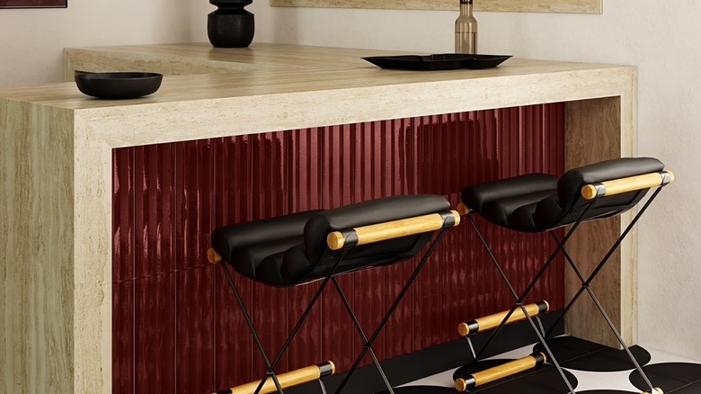 Dark ed glossy tiles under a kitchen island.