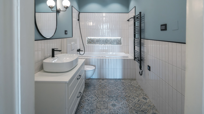 A bathroom with Spanish floor tiles and subway wall tiles.