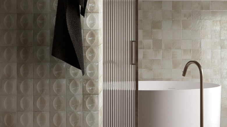 3D ivory tiles on a shower wall.