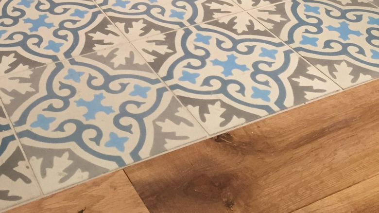Patterned encaustic cement tiles and hardwood floors.