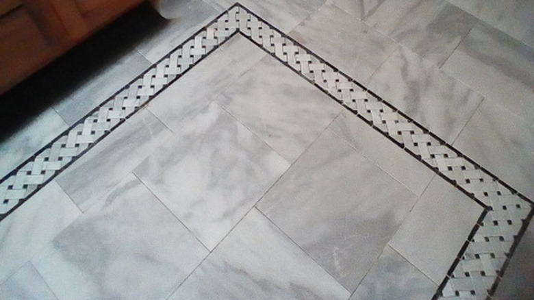 A marble floor with a tile border.